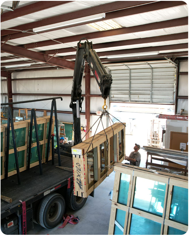 Glass cases being handled in the CLG warehouse